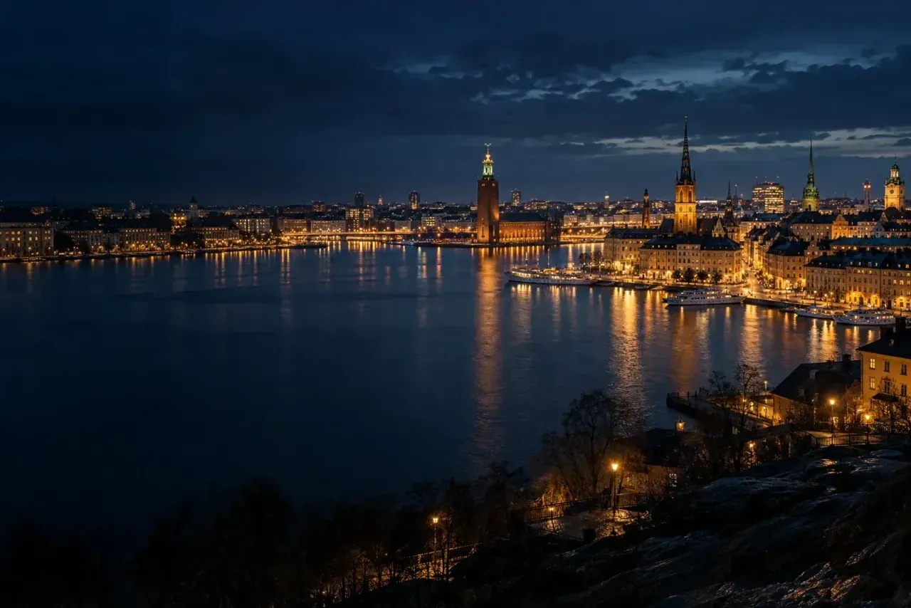 Stockholm at night across Riddarfjärden, from Södermalm towards City Hall and Gamla stan.